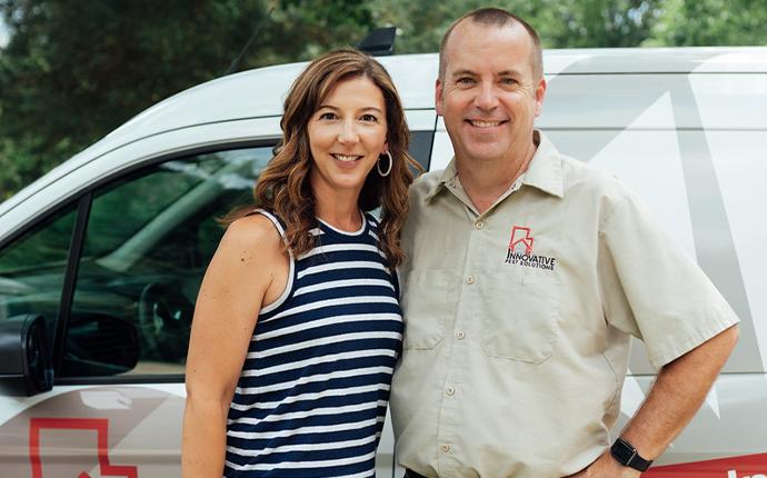 Kevin and Sarah from Innovative Pest Solutions in front of a van.