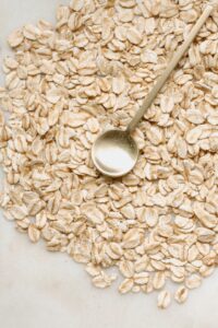 Pile of oatmeal with a metal spoon