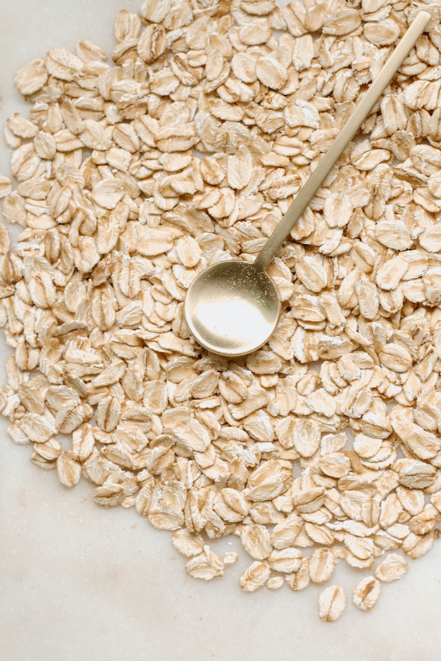 Pile of oatmeal with a metal spoon