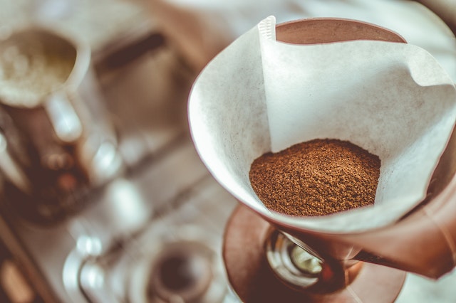 Light brown coffee grounds in a white filter