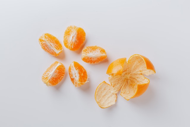 Orange peels with peeled oranges