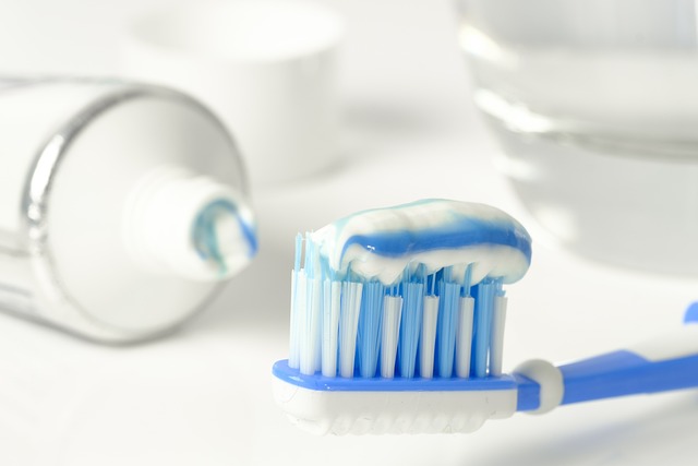 White tooth paste tube and blue toothbrush with toothpaste, one of the home remedies for ant bites