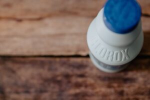 A bottle of Clorox bleach on a wooden table