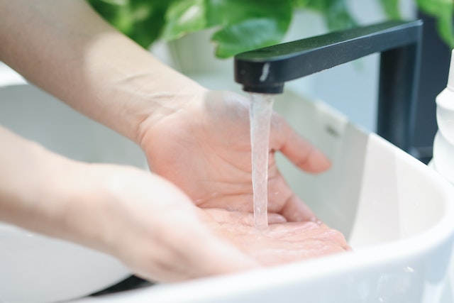 Person washing their hands to stay clean and prevent some of the diseases roaches carry 