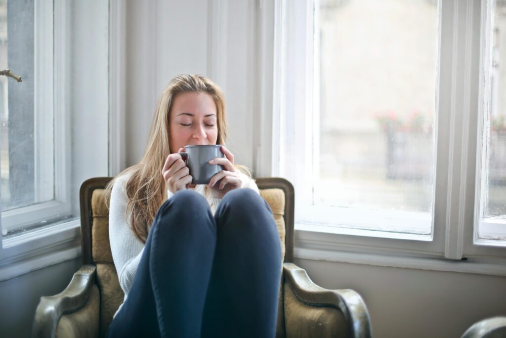 a woman pictured relaxing on the couch